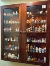 Large glass displey cabinet of various salt and pepper shaker sets.......