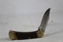 Buck Model 112 lock back with 3 inch blade. In good condition in original sheath.