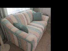 Matching conventional striped upholstered love seat and sofa