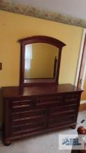 Cherry finished dresser with mirror on second floor