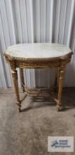Marble top stand with gold painted wooden base. 29-1/2 in. tall by 28-1/2 in. long by 19-1/2 in.