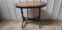 Wood...oval table with wicker base. 29 in. tall...by 36 in. long...by 18 in. wide
