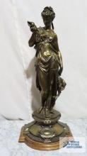 Woman holding seashell and fish metal sculpture on wooden base. 24 in. tall.
