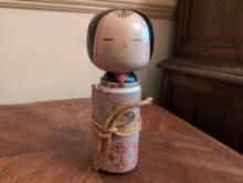(DR) JAPANESE KOKESHI WRAPPED SCROLL DOLL. MADE OF WOOD. IT MEASURES 9-1/4"T.