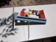 (GAR) UNIQUE HAND MADE AND PAINTED WINDMILL DEPICTING A WOMAN DOING HER LAUNDRY OUTSIDE WITH THE