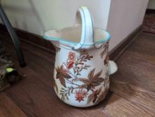 (LR) MADLEY P.B.&S. ANTIQUE HANDLED WATER PITCHER WITH FLORAL DETAILING. IT MEASURES 9"W X 7"D X