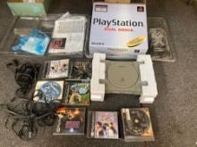 PlayStation 1 in box, cords, controller, memory cards, games