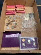 Rolls of pennies, a bag of nickels and a proof coin set