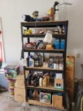 Contents of metal shelf including oils, paints, welding clamp, hardware, rust remover